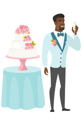 Wall Mural - Groom standing near cake with glass of champagne.