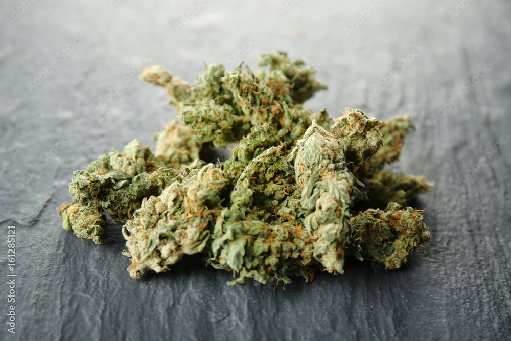 Heap of weed buds on dark background, closeup