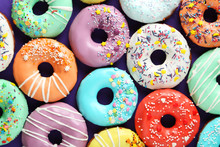 Tasty Donuts With Sprinkles On Paper Background