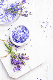 Fototapeta Lawenda - ingredients for lavender spa, flower and salt on white wooden background.