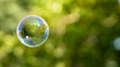 canvas print picture - House reflection in soap bubble on green, blurred background. Dream home. 
