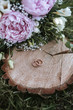 © Alina Schessler - wedding rings on wood with flowers