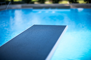 Closeup view of diving board in swimming pool