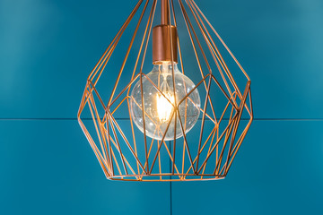 Luminarie of modern kitchen above the kitchen island. Diamond Copper Tone Wire Lamp. Retro, vintage inspired lamp. Copper Wire Pendant Light. Vintage Style Metal Cage