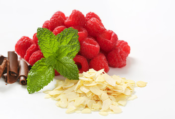 Canvas Print - Fresh raspberries, chocolate curls and sliced almonds