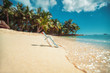 © ValentinValkov - Bottle with a message on a tropical island beach