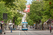 Zurich shopping street Bahnhofstrasse with tram and swiss flag