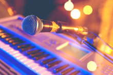 Live Music Background.Microphone And Piano  Keyboard On Stage.Concert And Musical Instrument