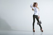 © julenochek - Full length casual young fashionable woman with a bag in light background