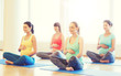 © Syda Productions - happy pregnant women exercising yoga in gym