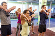 © Syda Productions - group of people with kettlebells exercising in gym