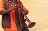 Man playing on ethnic musical instrument