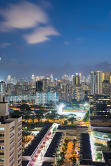 Wall Mural - Public residential condominium building complex at Toa Payoh neighborhood in Singapore, downtown skylines are in background. Aerial view at blue hour.