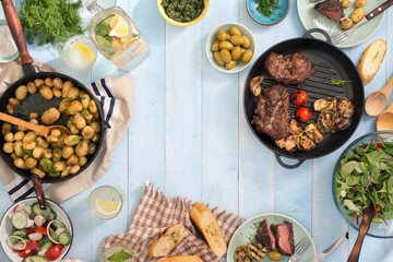 Canvas Print - Grilled meat, fried young potatoes, salad, snacks and homemade lemonade