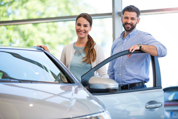 Wall Mural - Young couple buying a car
