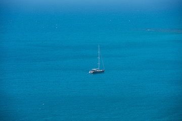 Wall Mural - Alone yacht sailing in open sea. Travel concept