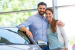 © pikselstock - Young couple buying a car