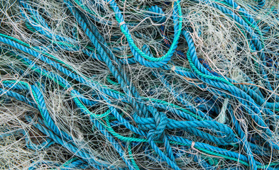 blue Tangled up used fishing nets detail background texture 