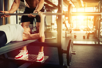 Wall Mural - Cute young woman exercising with personal trainer