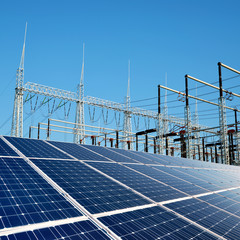 Wall Mural - solar energy panels in the background high voltage power substation.