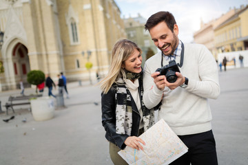 Tourist couple enjoying sightseeing and exploring city