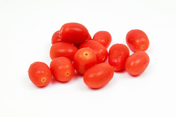 Wall Mural - Cherry tomatoes with basil leaf on a white background