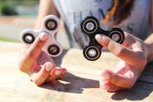 Women Hand Hold A White And Black Spinner