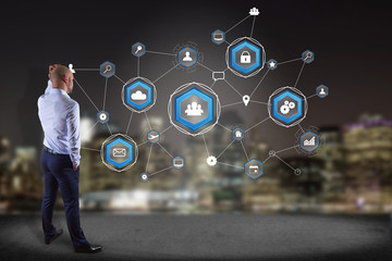 Poster - businessman in front of a wall with a business network connection displayed on a futuristic interfac