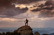 © danmir12 - Trekker hiking on a mountain with beautiful storm clouds in background