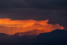 Beautiful Sunset Over Mountains With Storm Clouds In Background. Masivul Ceahlau, Romania.