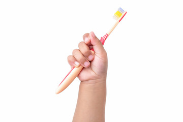 Child's hand holding a toothbrush, isolated on a white background