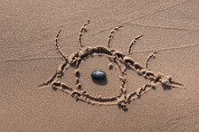Eye Drawn In The Sand. Beach Background. Top View