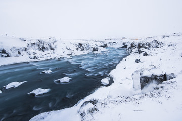 Wall Mural - Icelandic winter wild river flowing in the canyon