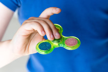 Young Girl Playing With Fidget Hand Spinner