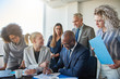 © Flamingo Images - Focused businesspeople working together at a table in an office