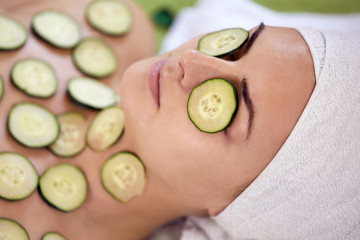 Shot of a young woman enjoying a facial treatment at a spa