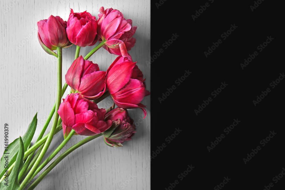Beautiful tulip flowers on white wooden table