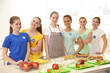 © Africa Studio - Young volunteers near table with different products indoors