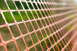 © Сyrustr - Plastic safety net for construction site. Construction mesh.