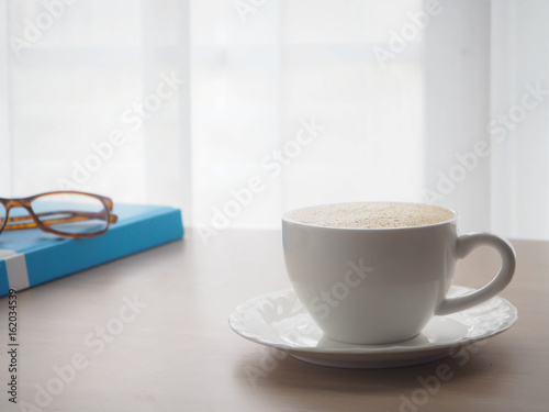 Wood Office Table With Cup Of Latte Coffee And Modern Eyeglasses