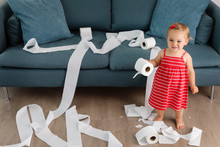 Smiling Toddler With Rolls Of Toilet Paper