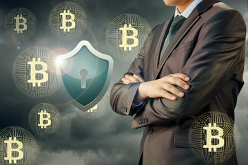 Wall Mural - Businessman protective shield and bitcoin .