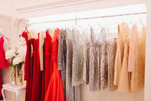 Grate Choice Of Gorgeous Fashion Dresses Hanging On Racks In Woman's Wardrobe. A Big Variety Of Sparkling Clothes. Difficult Choice, Women's Dream