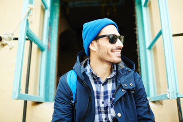 Wall Mural - Young hiker with backpack on his trip