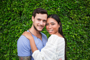 Smiling Attractive Interracial Couple Hugging