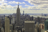 Fototapeta  - View of the Empire State Building  and lower Manhattan as seen from the Rockefeller Center. Afternoon, cloudy skies