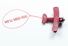 Writing We'll Miss You Red Toy Airplane With Talk Bubble On White Background