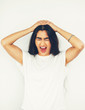 © Mangostar - Stressed Woman Putting Hands on Head and Screaming