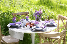 Beautiful Table Setting With Lilac Flowers Decoration Outdoors