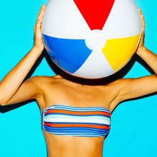 Tanned Girl In A Stylish Bikini And With A Beach Ball. Beach Style